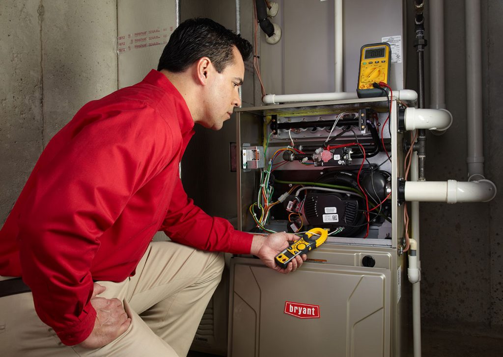 HVAC technician repairing an indoor furnace in Boulder
