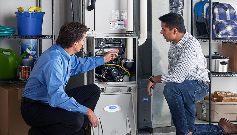 HVAC technician evaluating a furnace for repair or replacement in Boulder