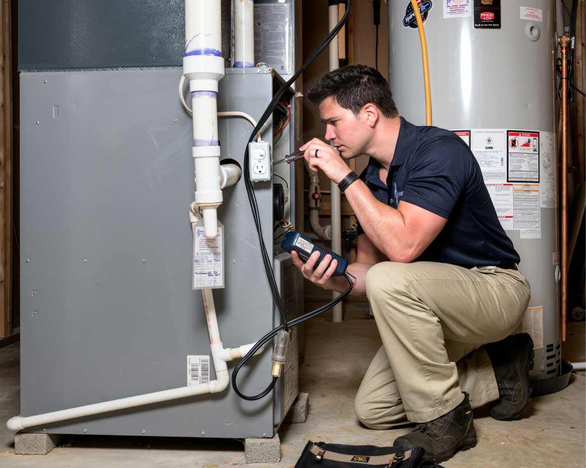 HVAC technician performing a furnace tune-up in Boulder
