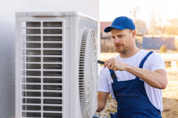 HVAC technician servicing an outdoor air conditioning unit in Boulder