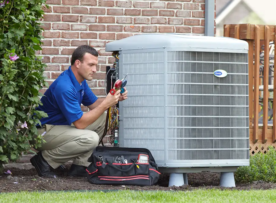 HVAC technician inspecting an outdoor air conditioning unit in Boulder