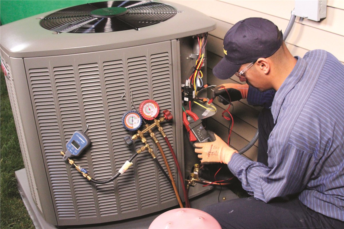 HVAC technician testing an outdoor air conditioning unit in Boulder